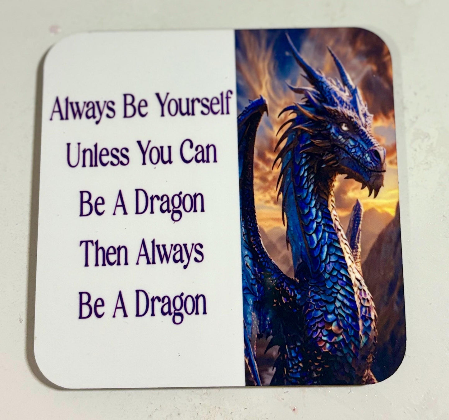 Coaster with a dragon and motivational quote.