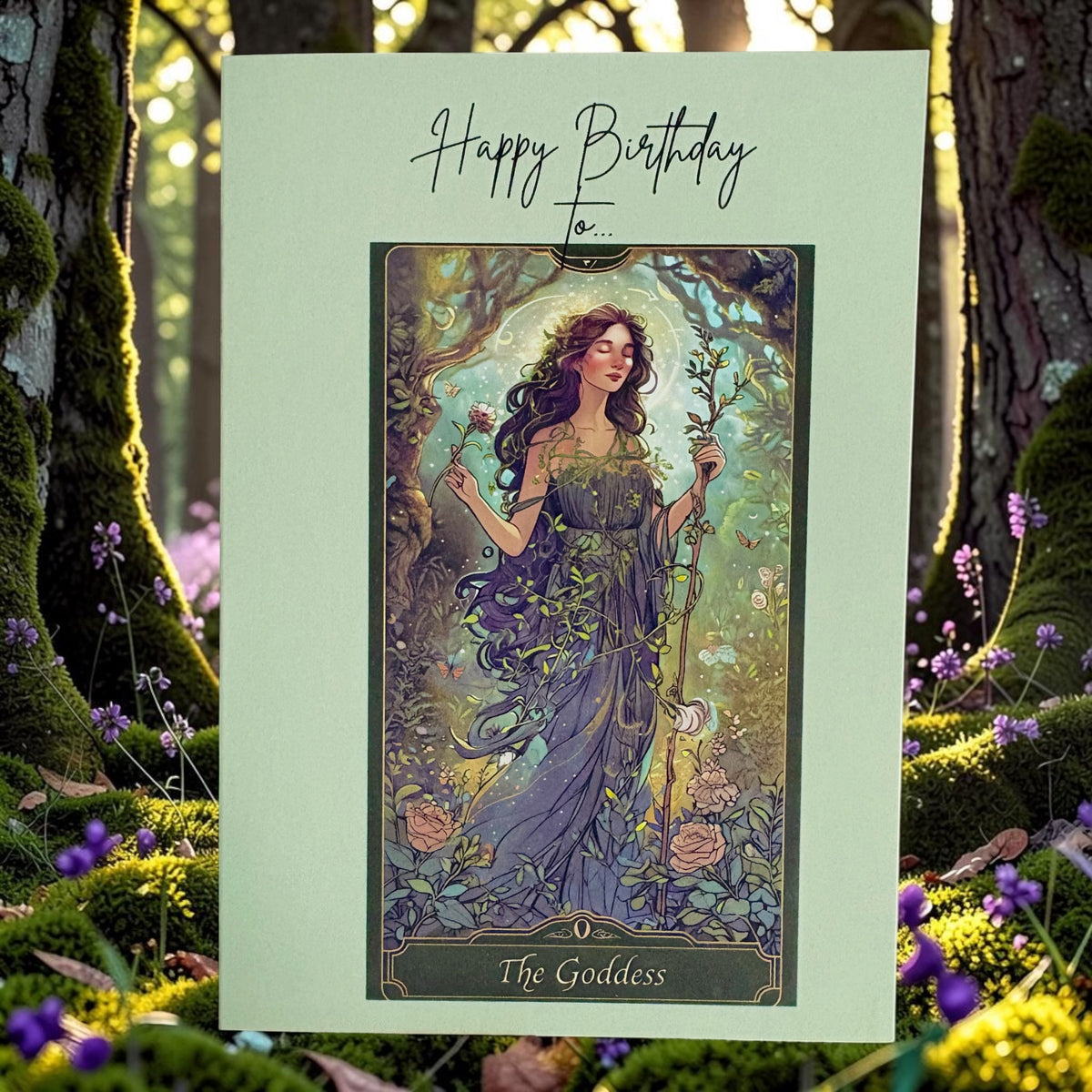 A square birthday card with a pale mint background and an art illustration of a goddess in a forest, reading 'Happy Birthday to.