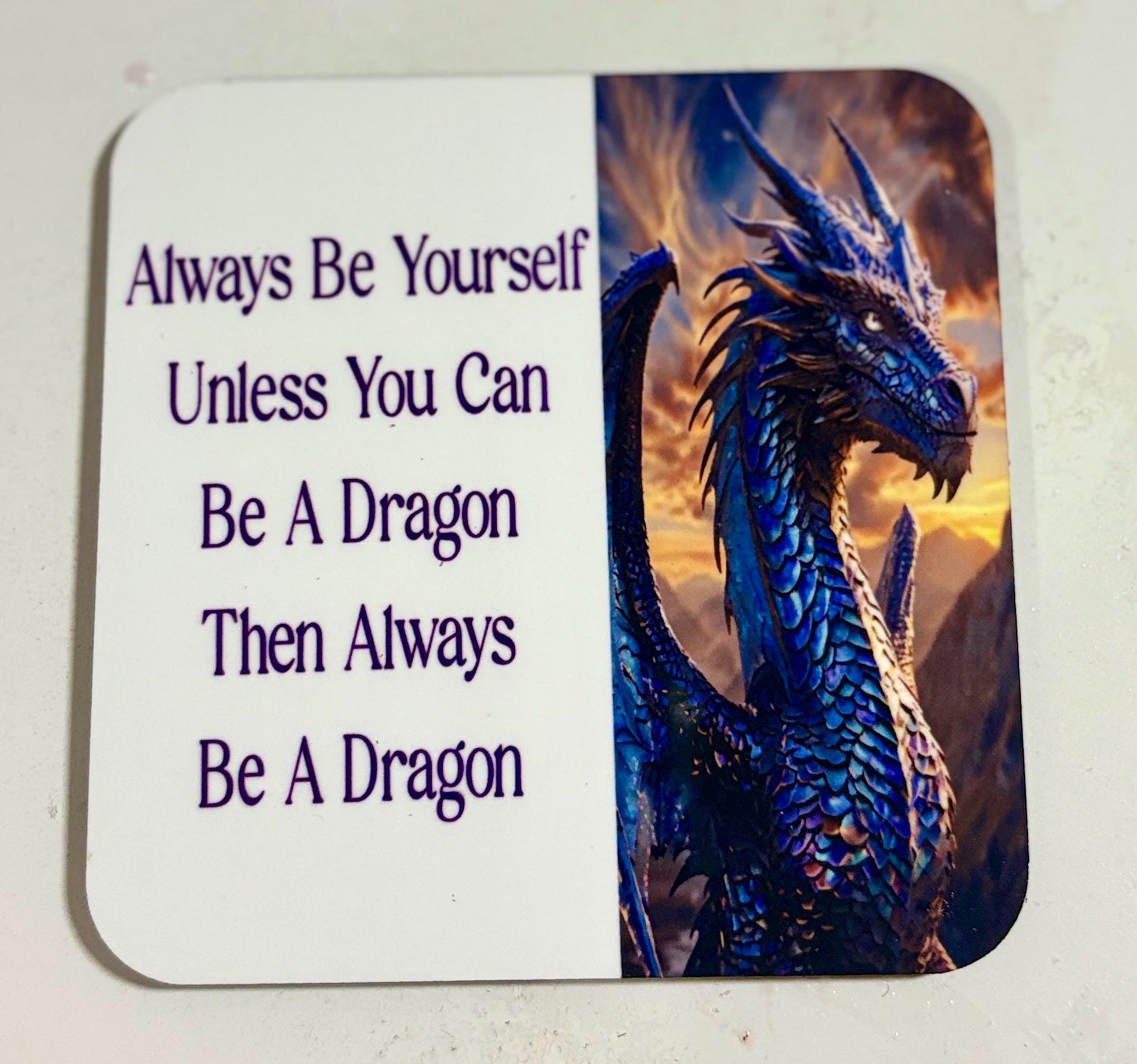 Coaster with a dragon and motivational quote.